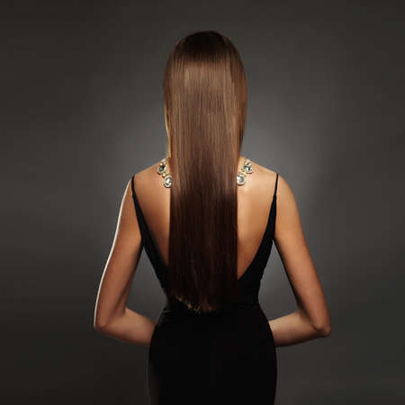 beautiful back of young woman in a black sexy dress.luxury.beauty brunette Girl with a necklace on her backの写真素材