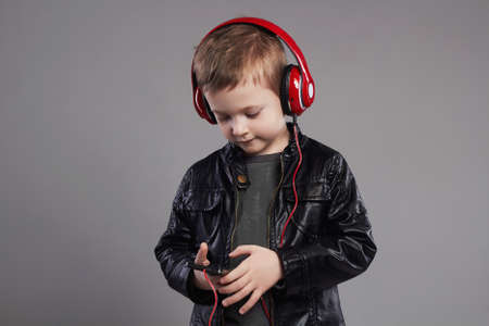 stylish little boy in headphones.handsome child listening musicの写真素材