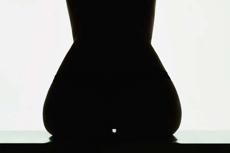 sexy naked woman.unusual photo of perfect body girl.booty silhouetteの写真素材