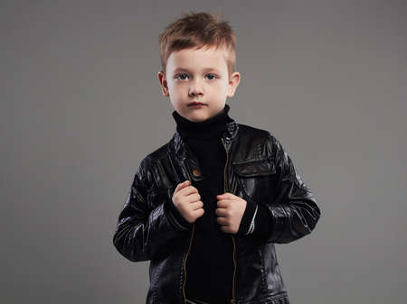 Fashionable child in leather coat.stylish little boy. spring fashion.funny 6 years old kidの写真素材