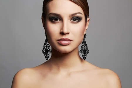 fashion portrait of girl in jewelry. beautiful sexy woman with short hair and make-upの写真素材