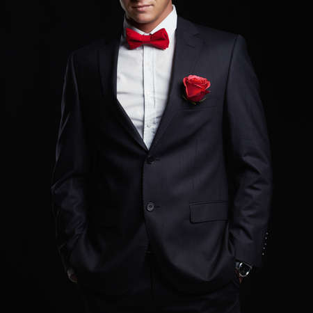 man with flower. young groom man in suit.elegant boy without faceの写真素材