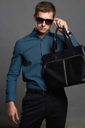 stylish man with a handbag. Handsome man in sunglassesの写真素材