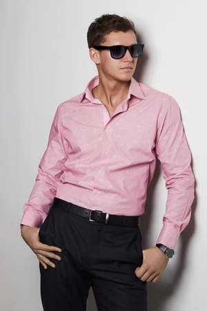 sexy boy in pink t-shirt and trendy glasses.handsome man in sunglassesの写真素材