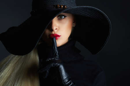 Beautiful woman in hat and leather gloves.halloween witchの写真素材
