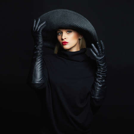 Beautiful woman in hat and leather gloves. halloween witchの写真素材