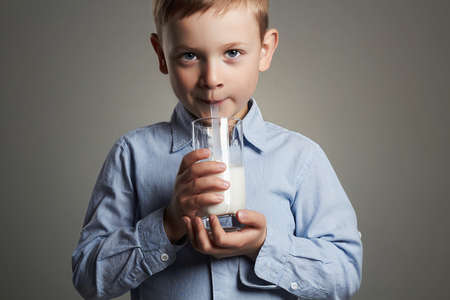 happy Child drinking milk.Little smiling Boy enjoy milk cocktail. Healthy lifeの写真素材