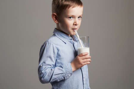 happy Child drinking milk.Little smiling Boy enjoy milk cocktail. Healthy lifeの写真素材