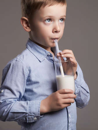happy Child drinking milk.Little smiling Boy enjoy milk cocktail. Healthy lifeの写真素材