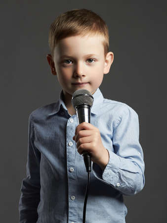 little boy with microphone. funny child singing in karaokeの写真素材