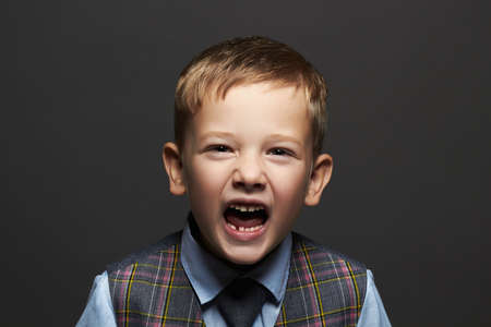 kids emotion.little boy.stylish funny child in suit and tie.childrenの写真素材