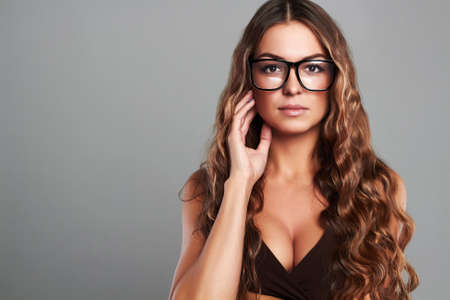 young beautiful sexy woman in glasses.Beauty brunette girl with healthy long hairの写真素材