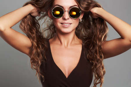 happy smiling beautiful young woman in sunglassesの写真素材