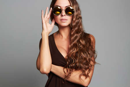 beautiful young woman in sunglasses.fashion beauty stylish girl with healthy long hairの写真素材