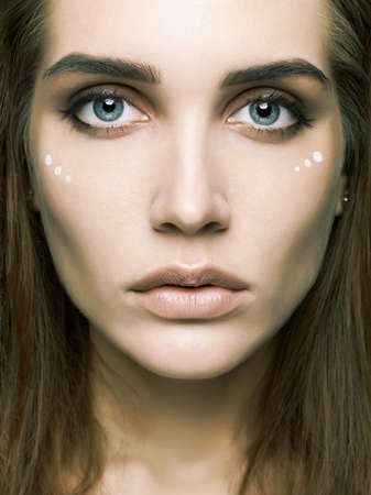 beautiful girl with fashion make-up portrait. pretty Amazon young woman. hippies.figures on faceの写真素材