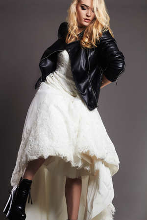 beautiful bride woman in wedding dress and leather jacket.fashion runaway Bride girlの写真素材