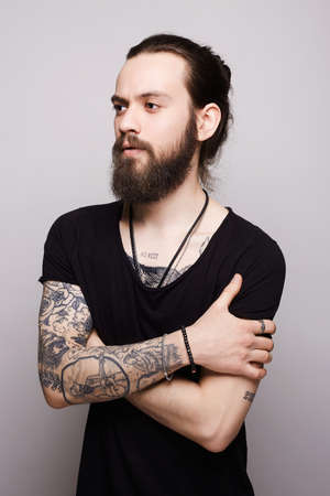 handsome bearded man.Brutal hipster boy with tattooの写真素材