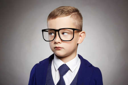 fashionable little boy in glasses.funny child in suit and glasses.business child in a three-piece suit.elegant kidの写真素材