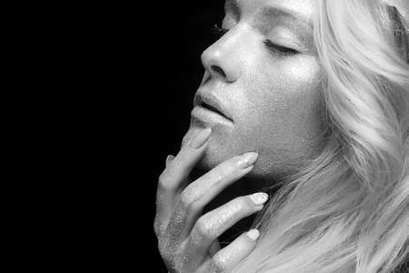 Silver Girl. Portrait of Beautiful Woman with Sparkles on her Face. Girl with Art Make-Upの写真素材