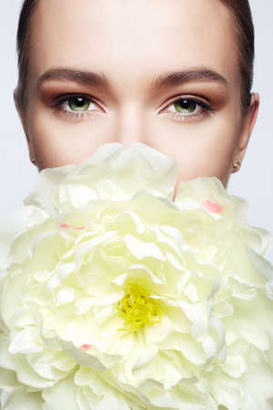 Beautiful young Woman with Flower. Beauty girl and Big peony flowerの写真素材