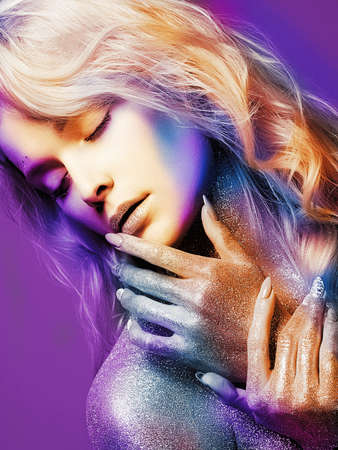 Beautiful Girl with Sparkles on her Face and Body. Young Woman with Art Make-Upの写真素材