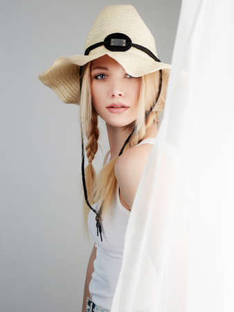 Beautiful Young Blond Country Woman. Cowgirl in Hat near the windowの写真素材