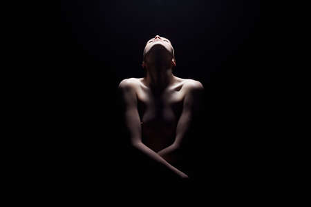 Nude Woman silhouette in the dark.Beautiful Sexy Naked Body Girlの写真素材