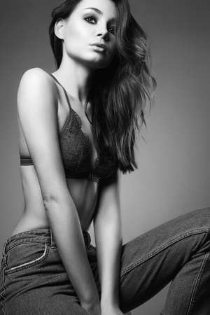 Fashion Black and white portrait of Young woman. Beautiful sexy model Girl in jeans and underwearの写真素材