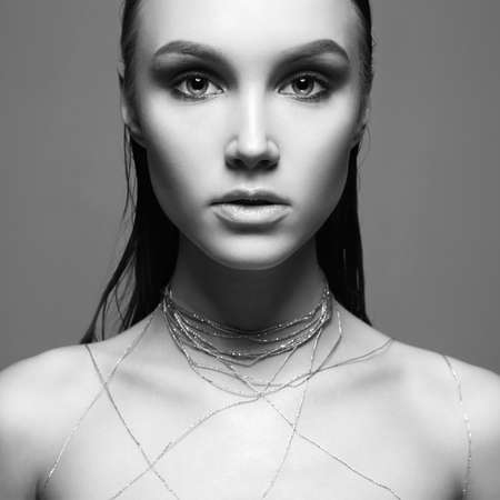 Beauty Make-up Girl. Beautiful young Woman with Makeup and thread on Body. Black and white portraitの写真素材