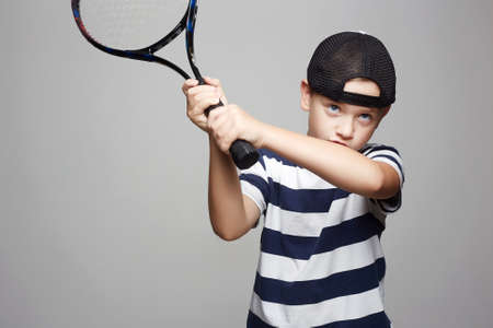 Child Boy Playing Tennis. Sport kids. Little Boy with Tennis Racketの写真素材