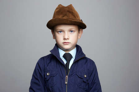 fashionable little boy in hat. fashion child portrait. elegant kid in tie, business child