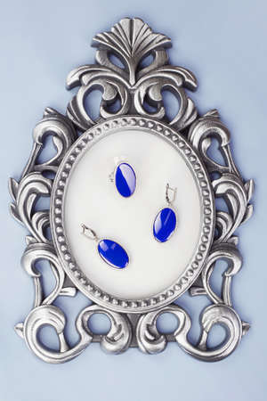 Woman's Jewellery. jewelry on vintage frame. Beautiful earrings and ring setの写真素材