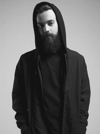 Fashionable Man in Hood. Bearded Handsome Boy. Stylish hipster