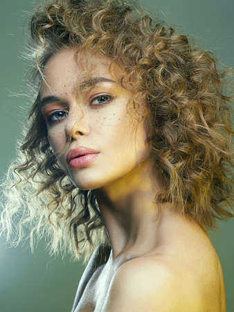 Beautiful freckles woman in green Light. amazing curly girl with make-up. beauty fashion portrait....