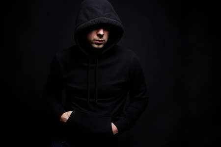 Man in Hood. Boy in a hooded sweatshirt. Male portraitの写真素材