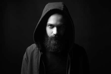 black and white portrait of Man in Hood. Boy in a hooded sweatshirt. portrait of bearded manの写真素材