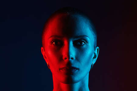 bald old woman head in color lights. Art colorful portrait with radiance faceの写真素材