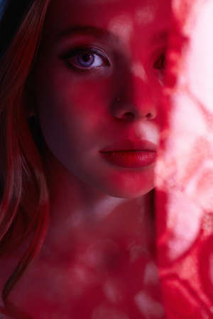 Blonde Girl in Red Lace. Beautiful young woman with blue eyesの写真素材