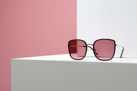 Trendy Women's glasses. fashion still life. female sunglasses on withe cubeの写真素材