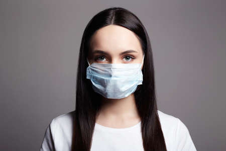 Young Woman in Mask. Epidemic concept. Coronavirus. medical masked beautiful girl.の写真素材