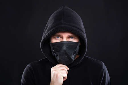 Man in Mask and Hood. Boy in Black Mask and Hoodie. Coronavirus epidemic