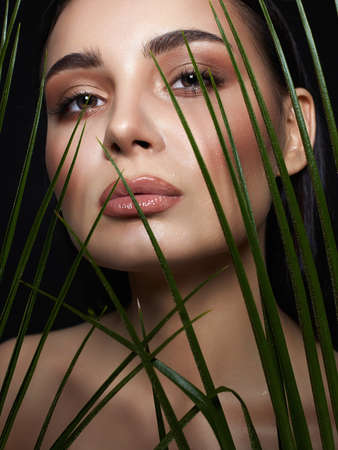 beautiful girl in palms. Beautiful woman with Make-up. Beauty Portrait. wild woman in Jungle.の写真素材