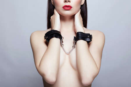 perfect Body Naked Girl in handcuffs. slave Beautiful young Woman with red lipstickの写真素材