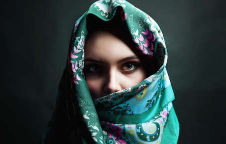 beautiful young woman in color veil. beauty girl in colorful hijab. fashion oriental woman. ethnic peopleの写真素材