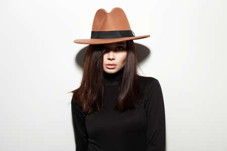 Beautiful young woman in hat. fashion beauty brunette girlの写真素材