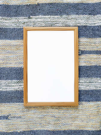 Beautiful white frame for a picture on carpet. Unusual interior photoの写真素材
