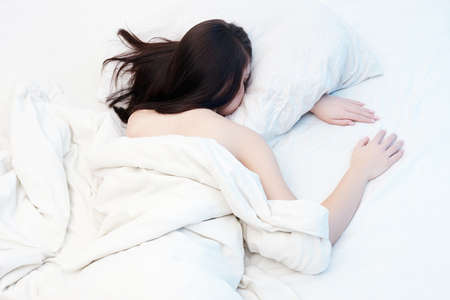 Lifestyle portrait of cute girl sleeping on bed. beautiful sensual woman in white morning bed
