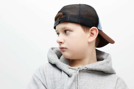 little boy in cap and hoodie. Close-up portrait of stylish teenager boy. Childの写真素材