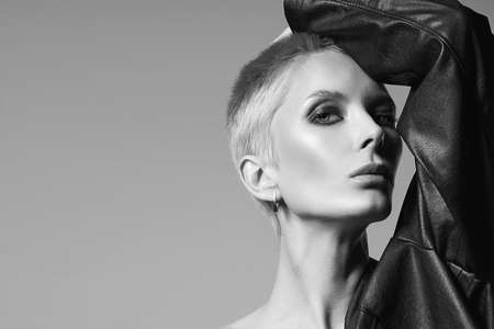 Fashionable beautiful woman with short hair. beauty blond age woman in leather