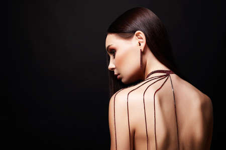 beautiful young woman with necklace on her naked back. Nude Girl with jewelryの写真素材